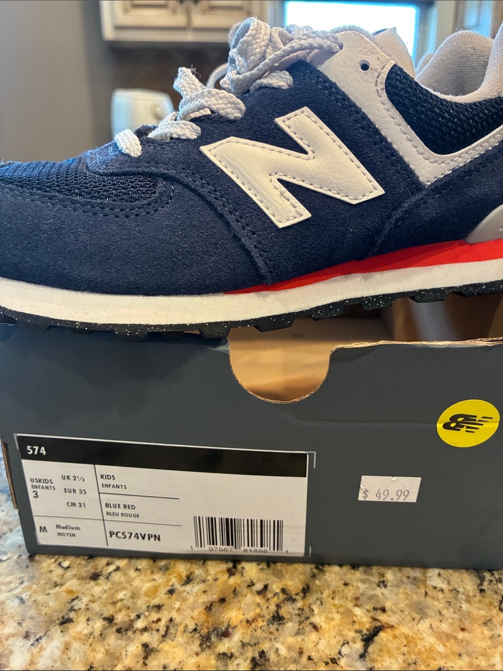 New Balance Kids Navy Blue and White Sneaker with Red Accent